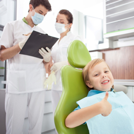 child in chair at dentist