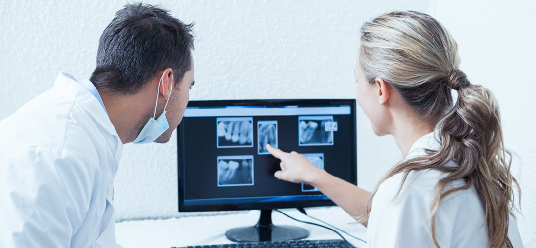 dentist examining mouth xrays