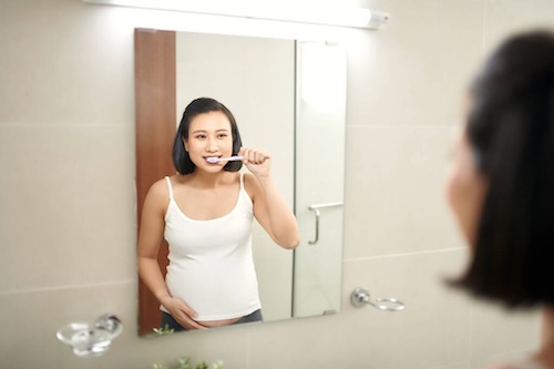 Pregnant Woman Brushing Teeth